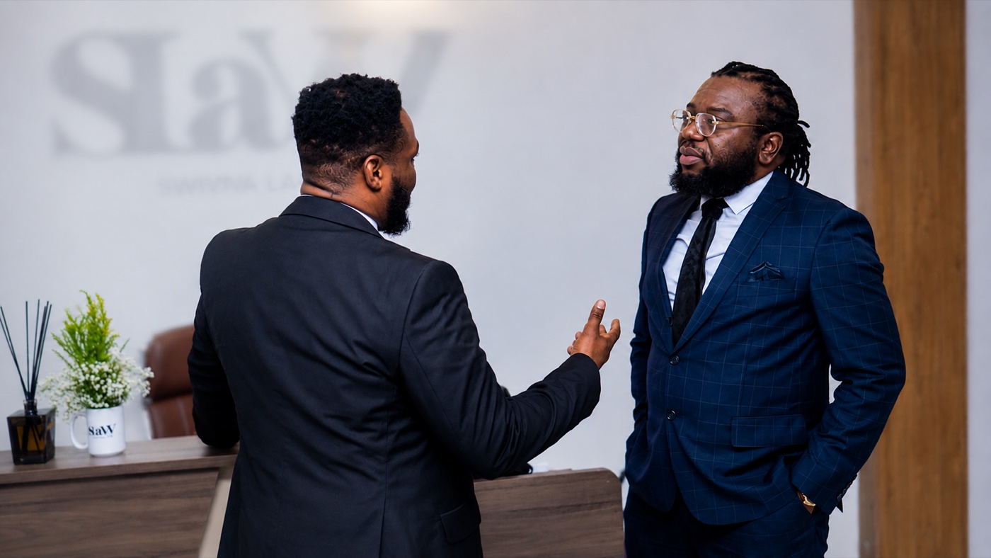 Two SLAW solicitors in conversation at the firm's office reception